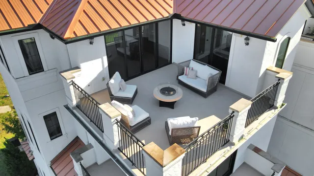 a backyard of a house with seating space and wooden floor