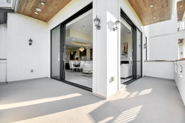 a living room with furniture a fireplace and a chandelier