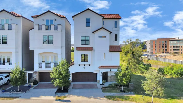 a front view of a house with a yard and a garage