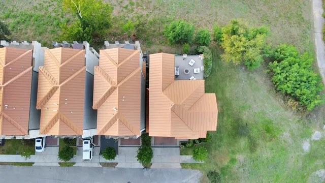 an aerial view of residential houses with outdoor space
