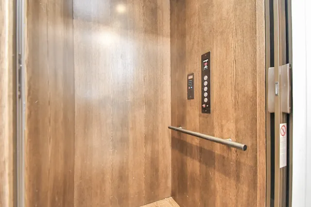 a kitchen with granite countertop a table chairs stainless steel appliances and cabinets