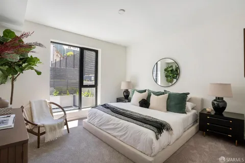 a living room with furniture and a floor to ceiling window