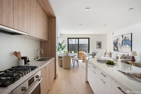a living room with furniture potted plant and a large window