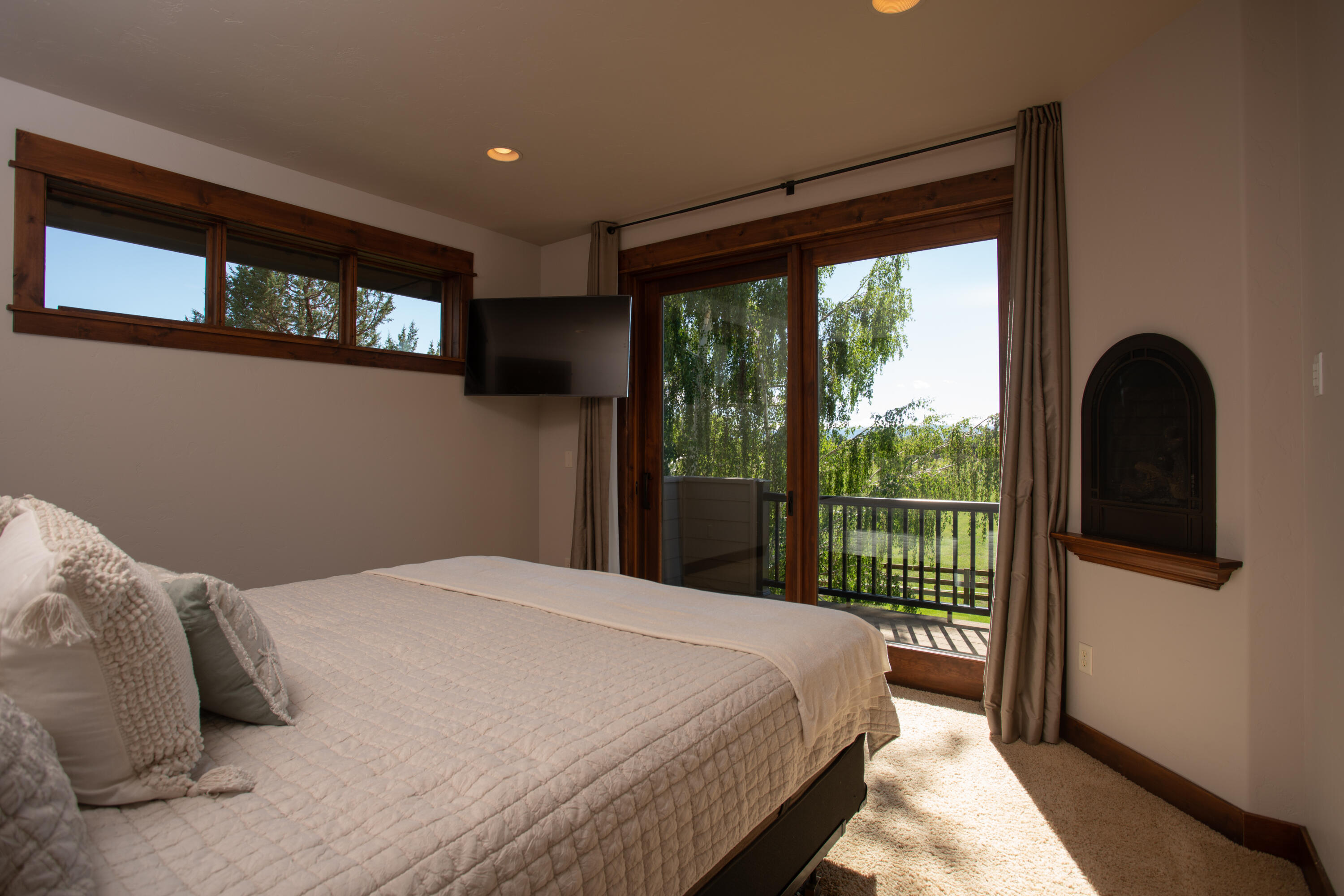 61405 Ward Road Bend, OR 97702 - Photo 10 of 37 a bedroom with a large bed and a large window