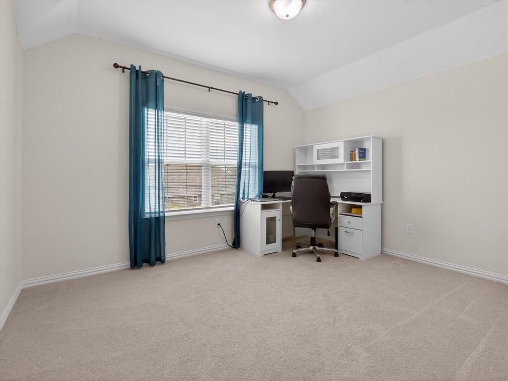 636 Corner Post Path Celina, TX 75009 - Photo 30 of 40 Carpeted room featuring a window with horizontal blinds and drapery, neutral wall paint, and a built-in flush mount ceiling light fixture