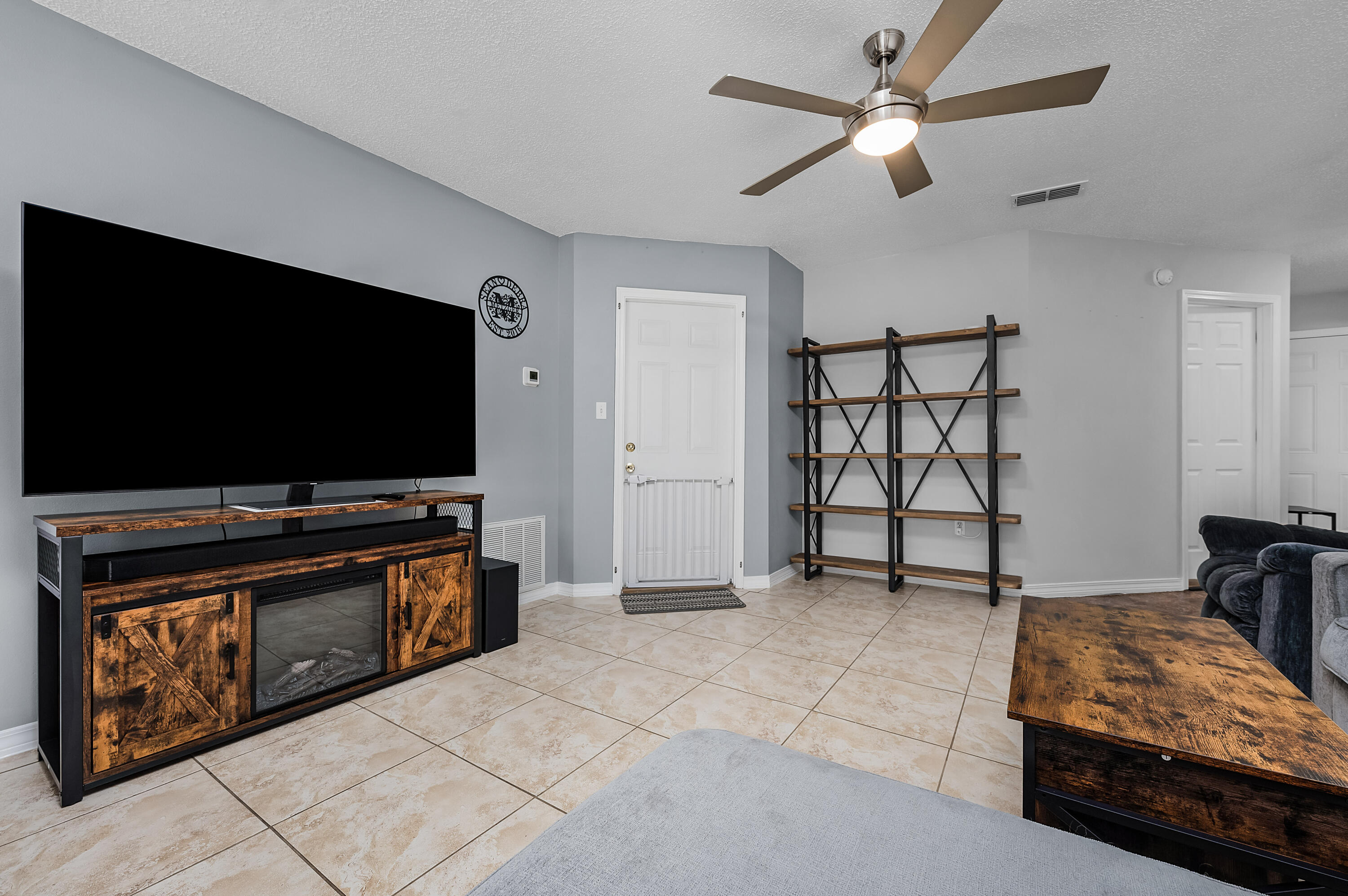 281 Limestone Circle Crestview, FL 32539 - Photo 12 of 46 a living room with furniture and a flat screen tv