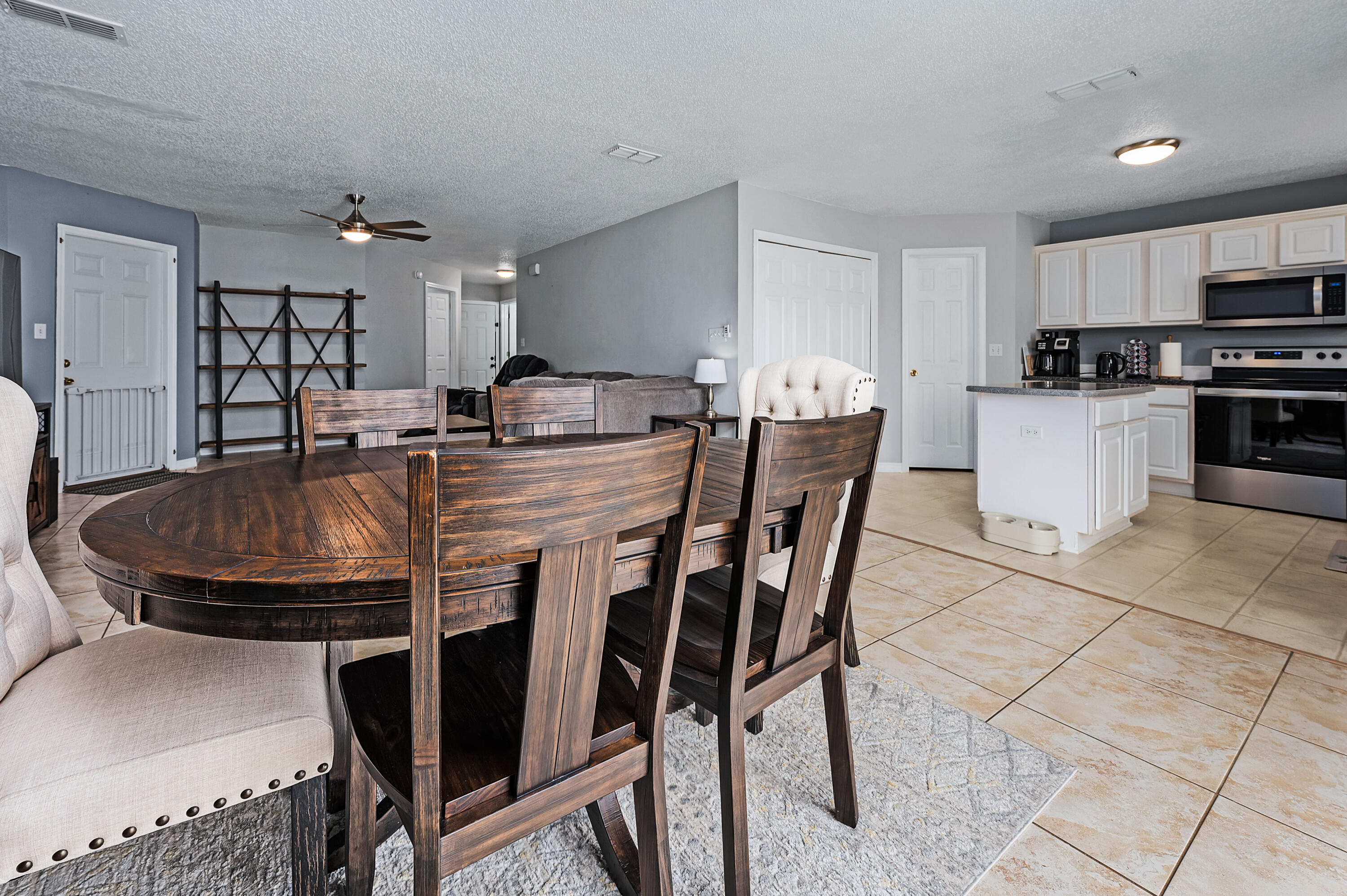 281 Limestone Circle Crestview, FL 32539 - Photo 14 of 46 a kitchen with stainless steel appliances kitchen island granite countertop a kitchen island a stove a table and chairs