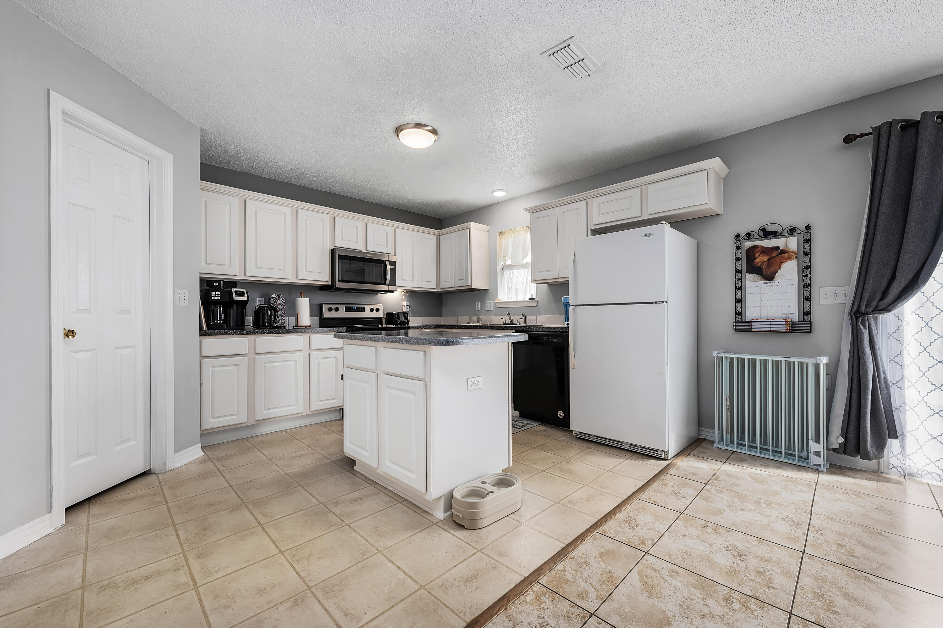 281 Limestone Circle Crestview, FL 32539 - Photo 17 of 46 a kitchen with white cabinets and white appliances
