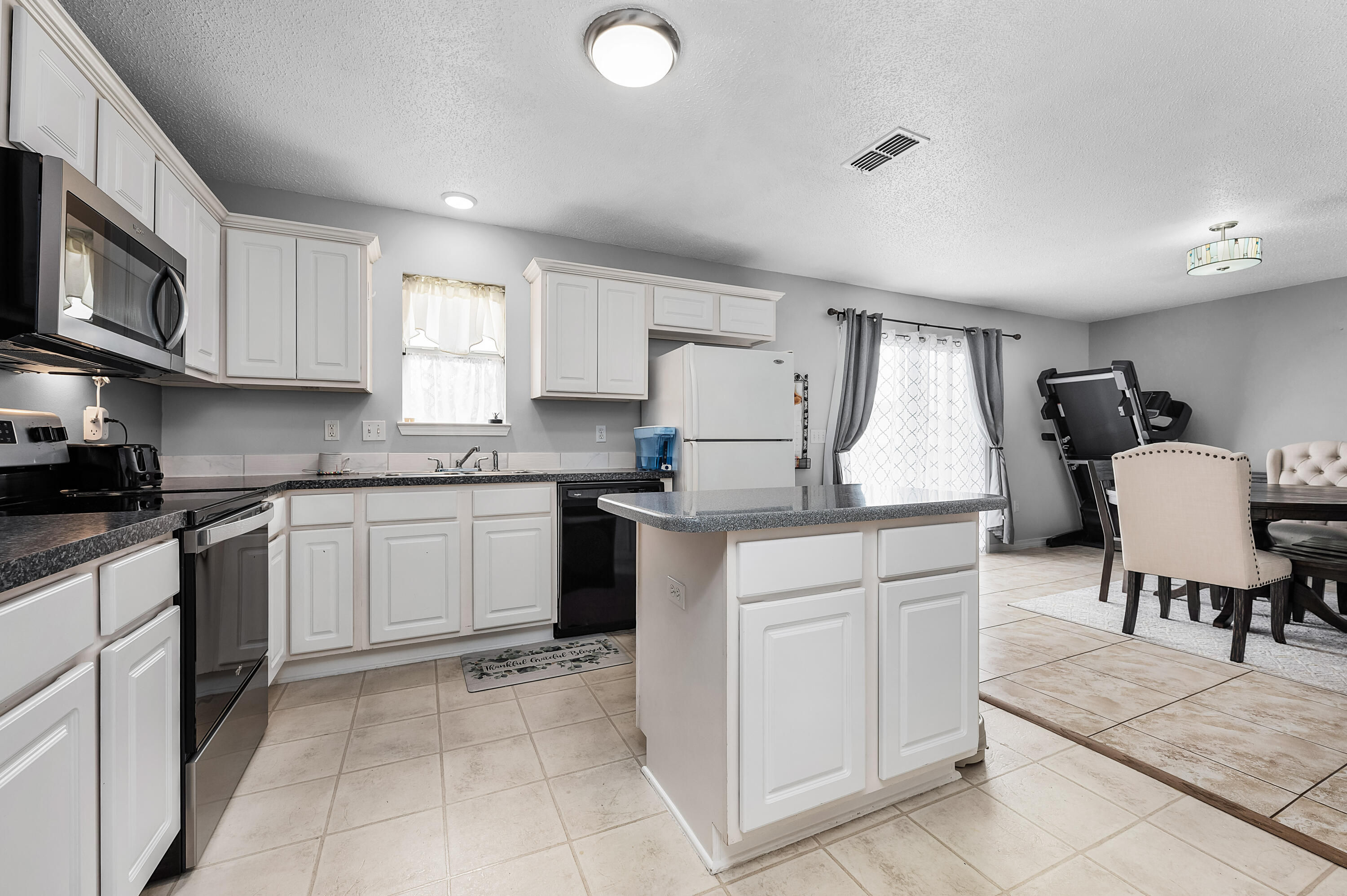 281 Limestone Circle Crestview, FL 32539 - Photo 18 of 46 a kitchen with cabinets and chairs