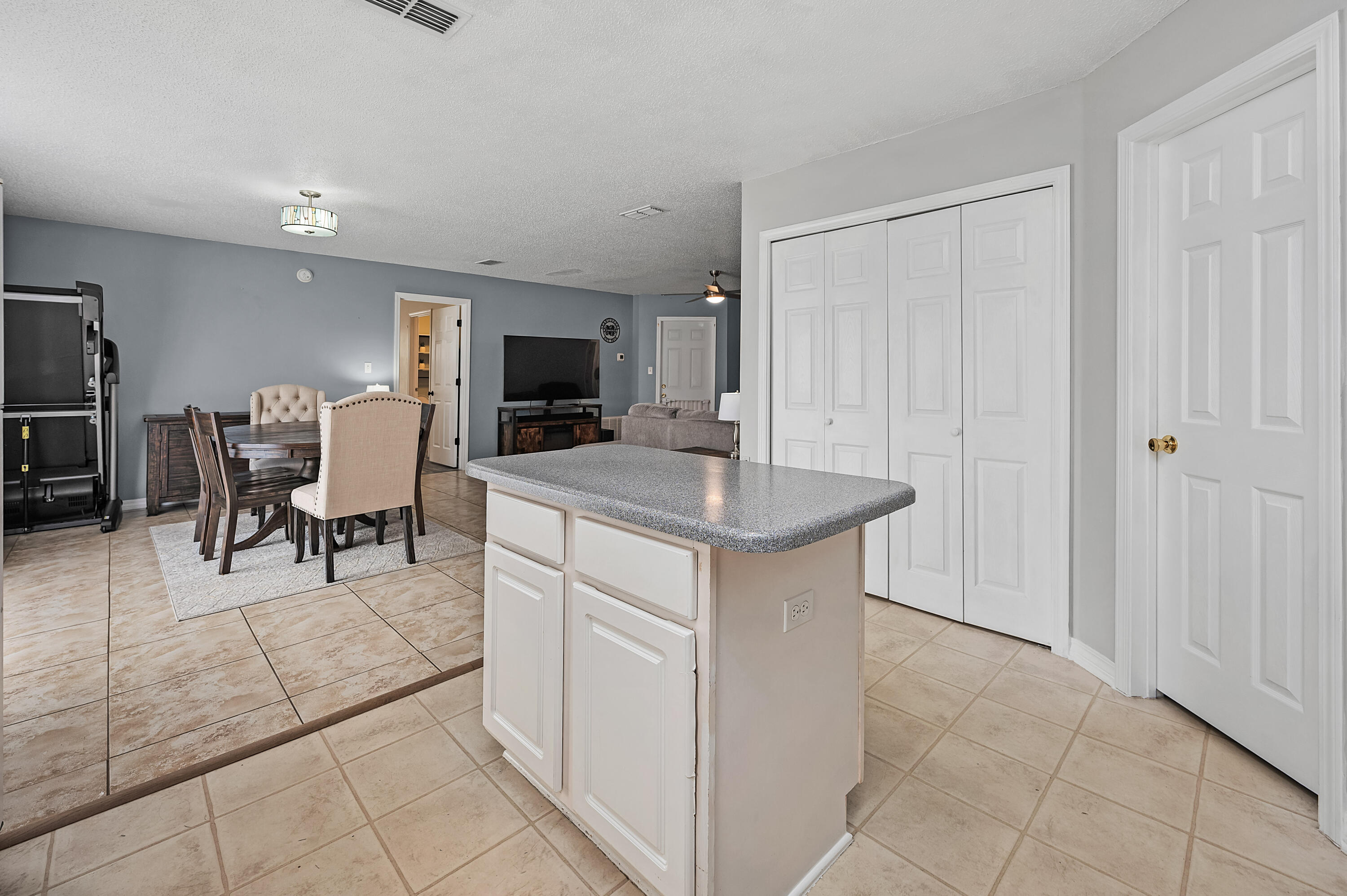 281 Limestone Circle Crestview, FL 32539 - Photo 19 of 46 a kitchen with kitchen island granite countertop furniture a sink a counter top space and stainless steel appliances
