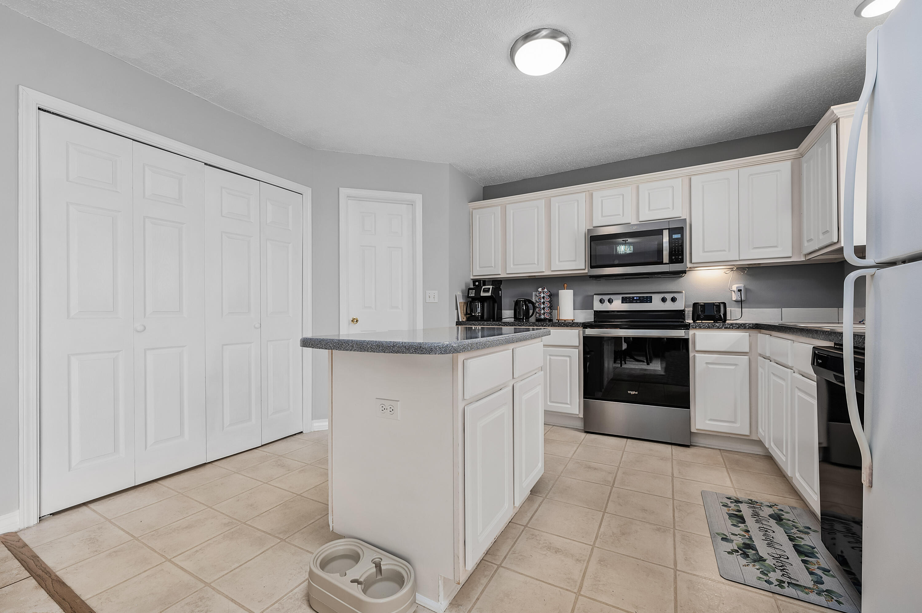 281 Limestone Circle Crestview, FL 32539 - Photo 20 of 46 a kitchen with granite countertop white cabinets and stainless steel appliances