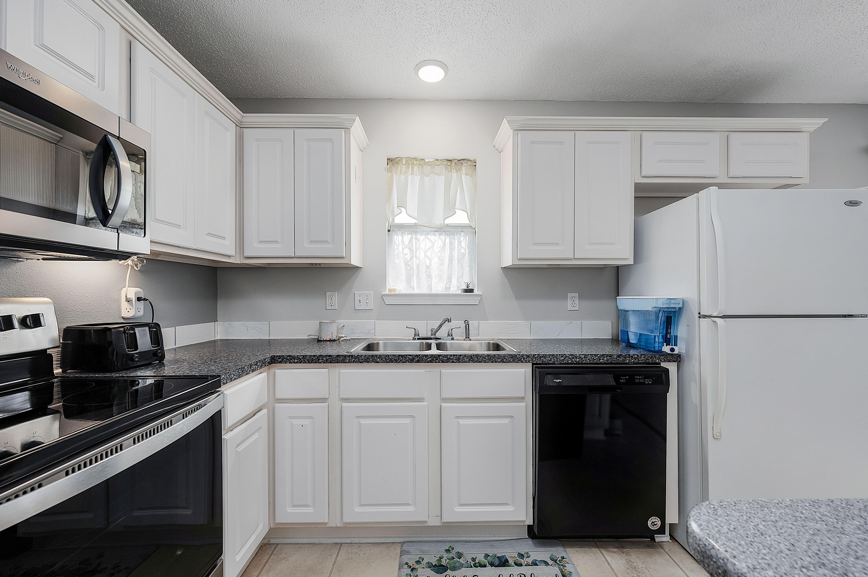 281 Limestone Circle Crestview, FL 32539 - Photo 21 of 46 a kitchen with granite countertop a refrigerator stove and sink
