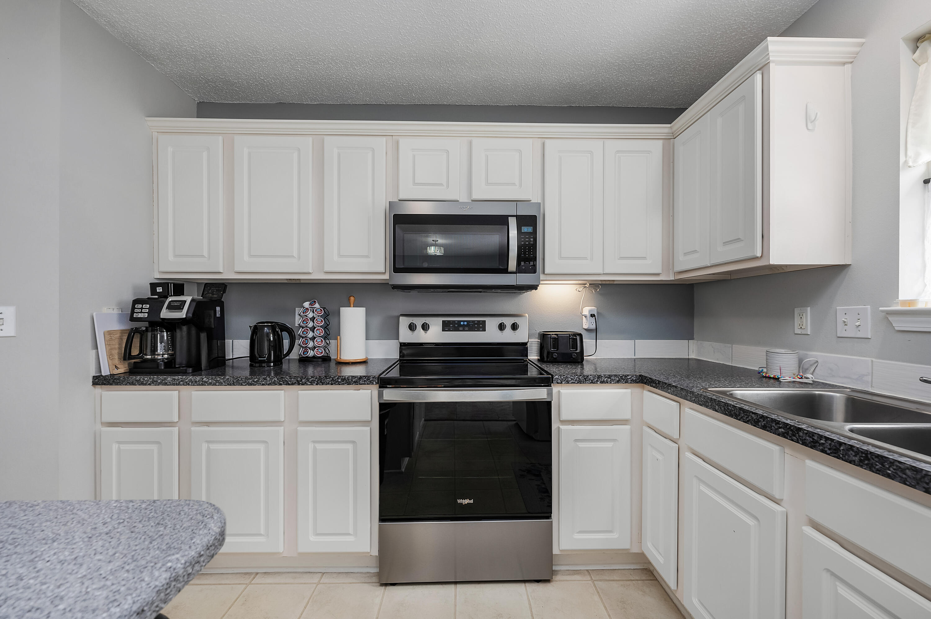 281 Limestone Circle Crestview, FL 32539 - Photo 22 of 46 a kitchen with granite countertop white cabinets and stainless steel appliances