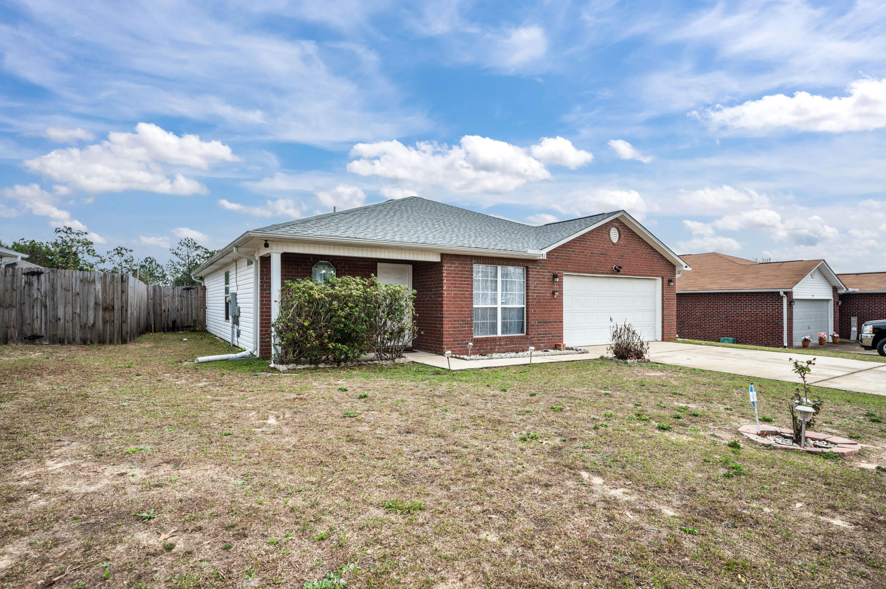 281 Limestone Circle Crestview, FL 32539 - Photo 3 of 46 a view of a house with a yard and wooden fence