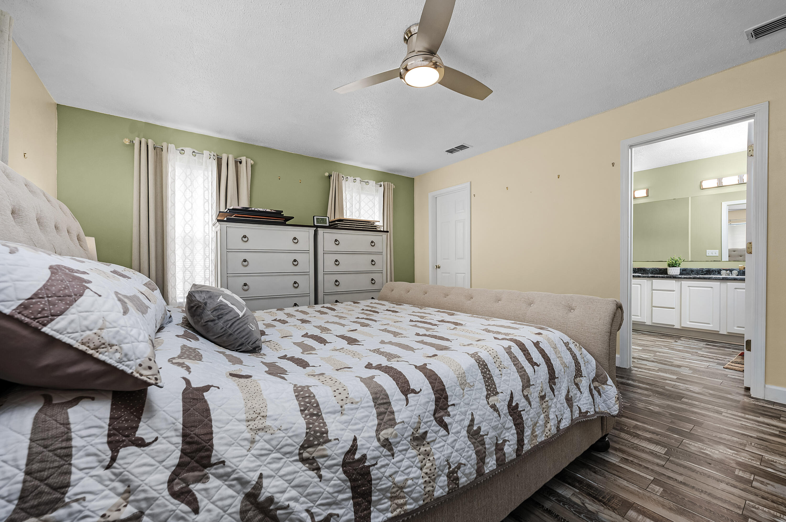 281 Limestone Circle Crestview, FL 32539 - Photo 32 of 46 a bedroom with a bed and a chandelier