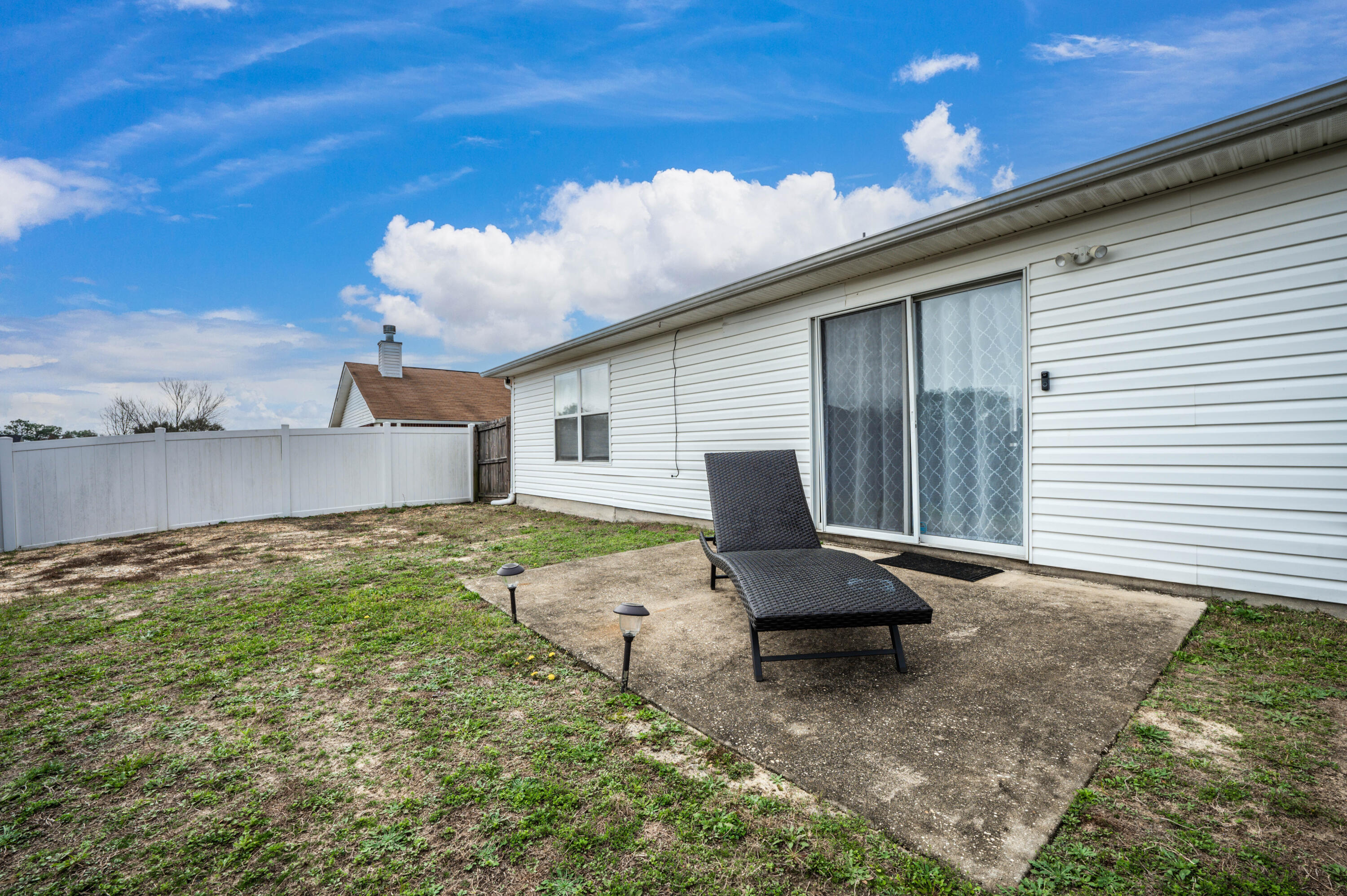 281 Limestone Circle Crestview, FL 32539 - Photo 43 of 46 a backyard of a house with table and chairs