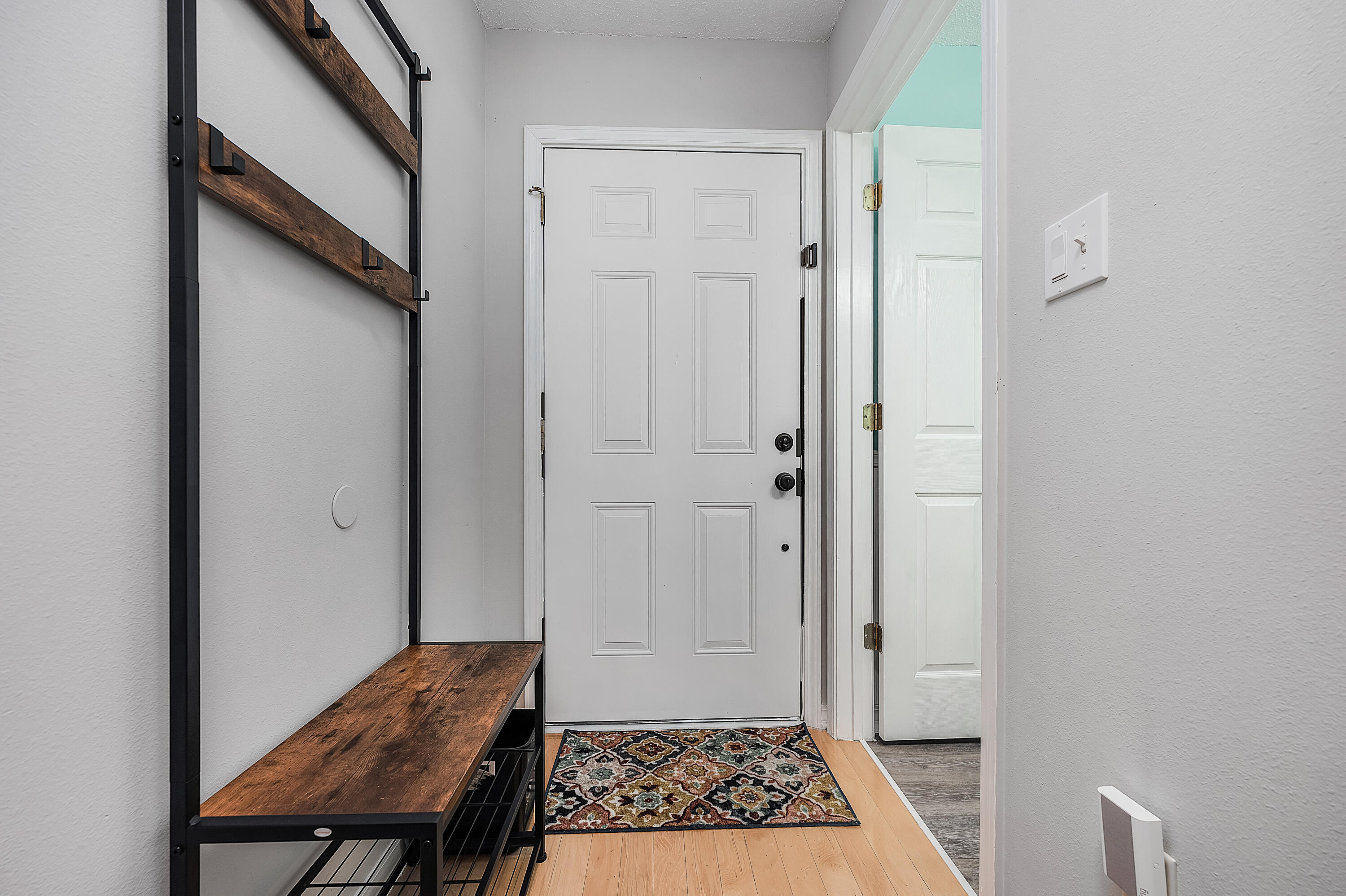 281 Limestone Circle Crestview, FL 32539 - Photo 6 of 46 a view of a hallway with wooden floor and a bathroom