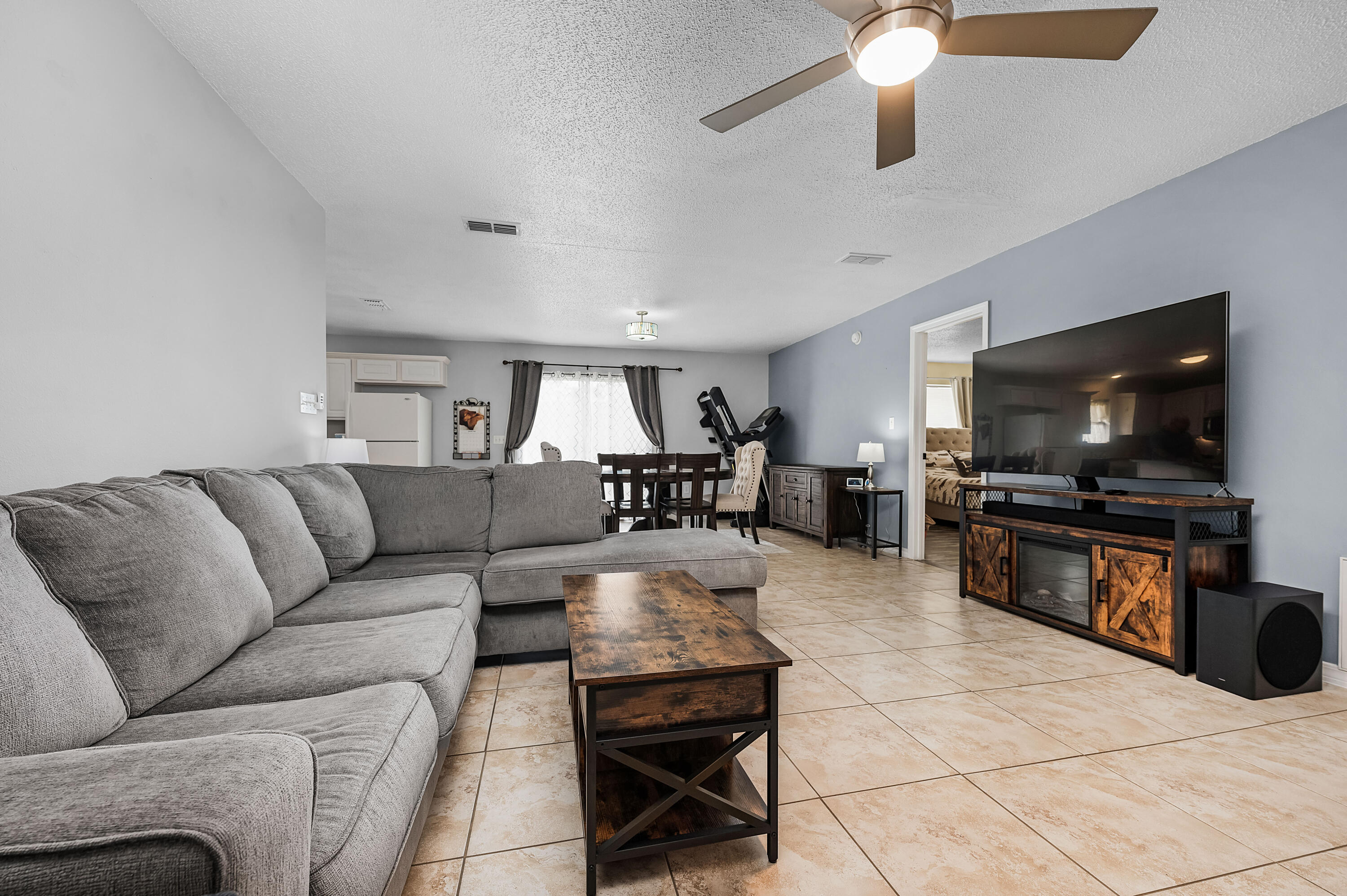 281 Limestone Circle Crestview, FL 32539 - Photo 8 of 46 a living room with furniture and a flat screen tv