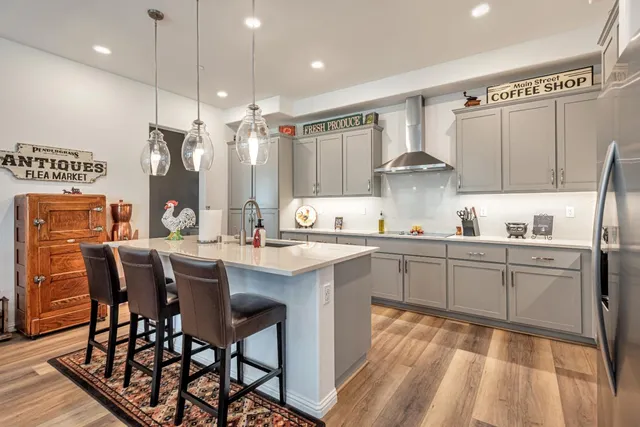a kitchen with a table chairs sink and cabinets
