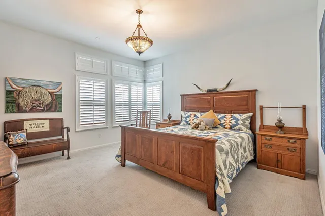 a bedroom with a bed and a chandelier