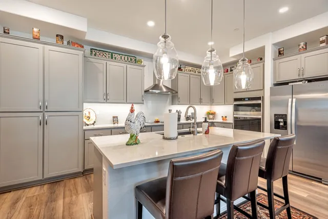 a kitchen with refrigerator and cabinets