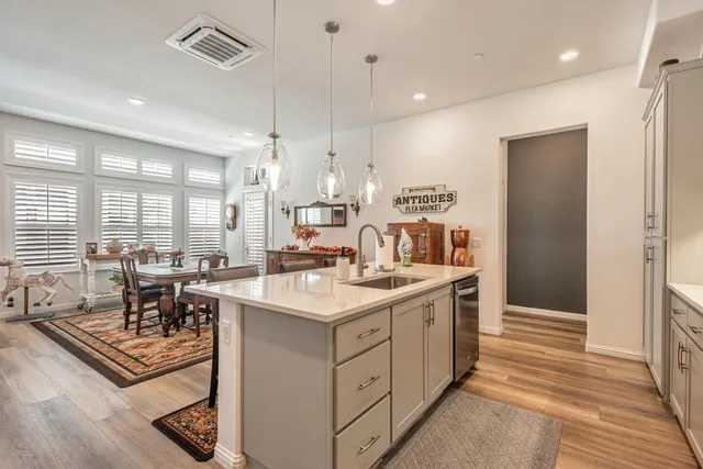 a kitchen with a sink stove and cabinets