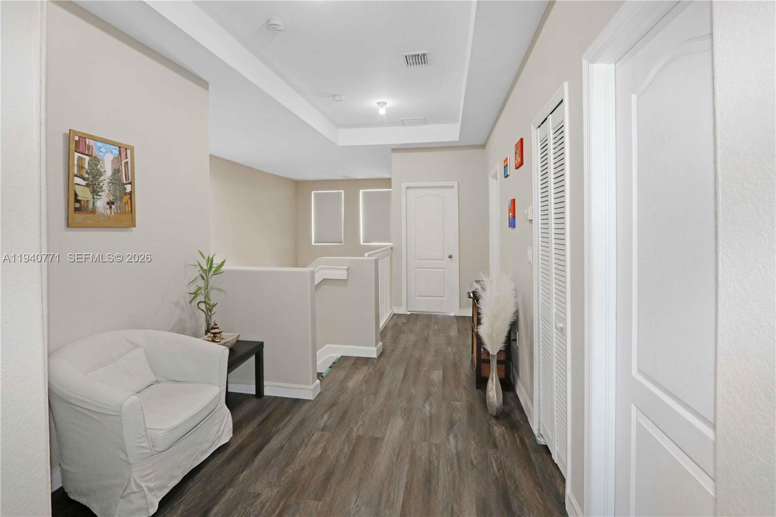 14973 Southwest 8th Terrace Miami, FL 33194 - Photo 22 of 32 a hallway with furniture and wooden floor