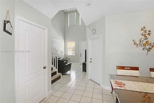 a view of kitchen with furniture and refrigerator