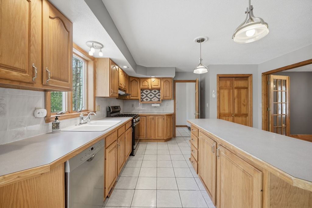 37 Wyndermere Place Ludlow, MA 01056 - Photo 5 of 42 a kitchen with stainless steel appliances a sink stove and cabinets
