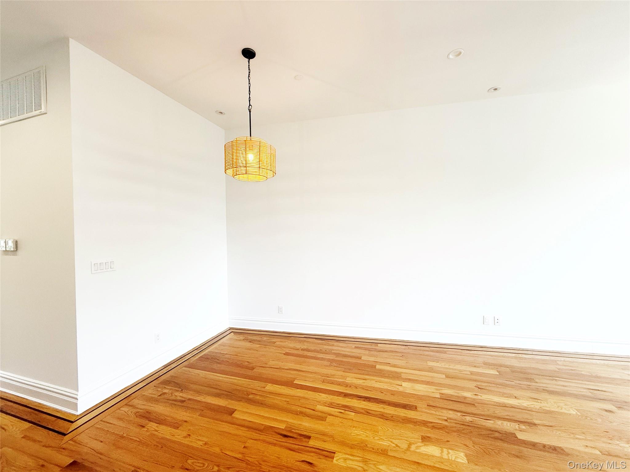 333 Tompkins Avenue, Unit PH2 Brooklyn, NY 11216 - Photo 18 of 33 a view of a room with wooden floor and white walls