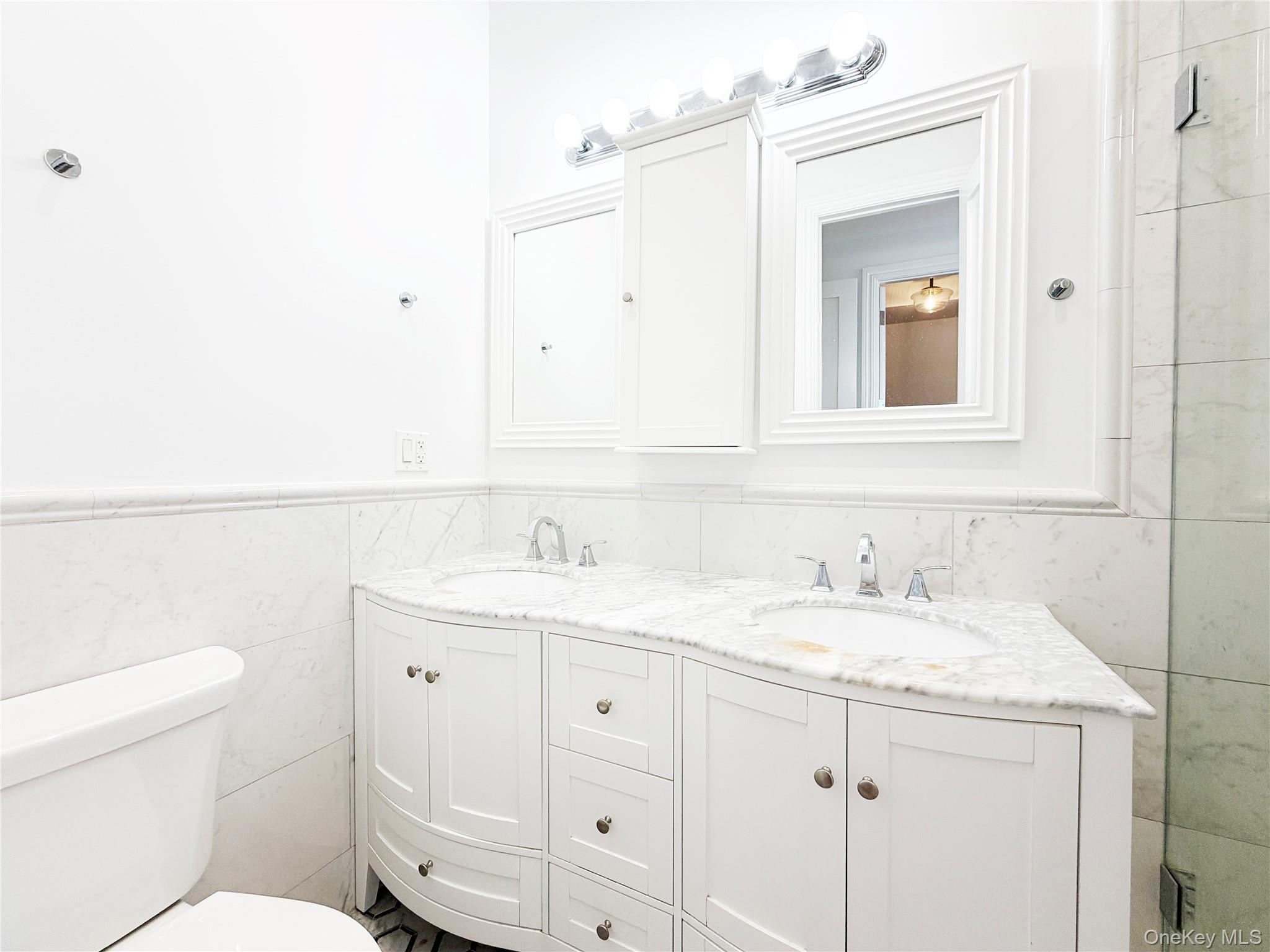 333 Tompkins Avenue, Unit PH2 Brooklyn, NY 11216 - Photo 21 of 33 a bathroom with a toilet sink and mirror