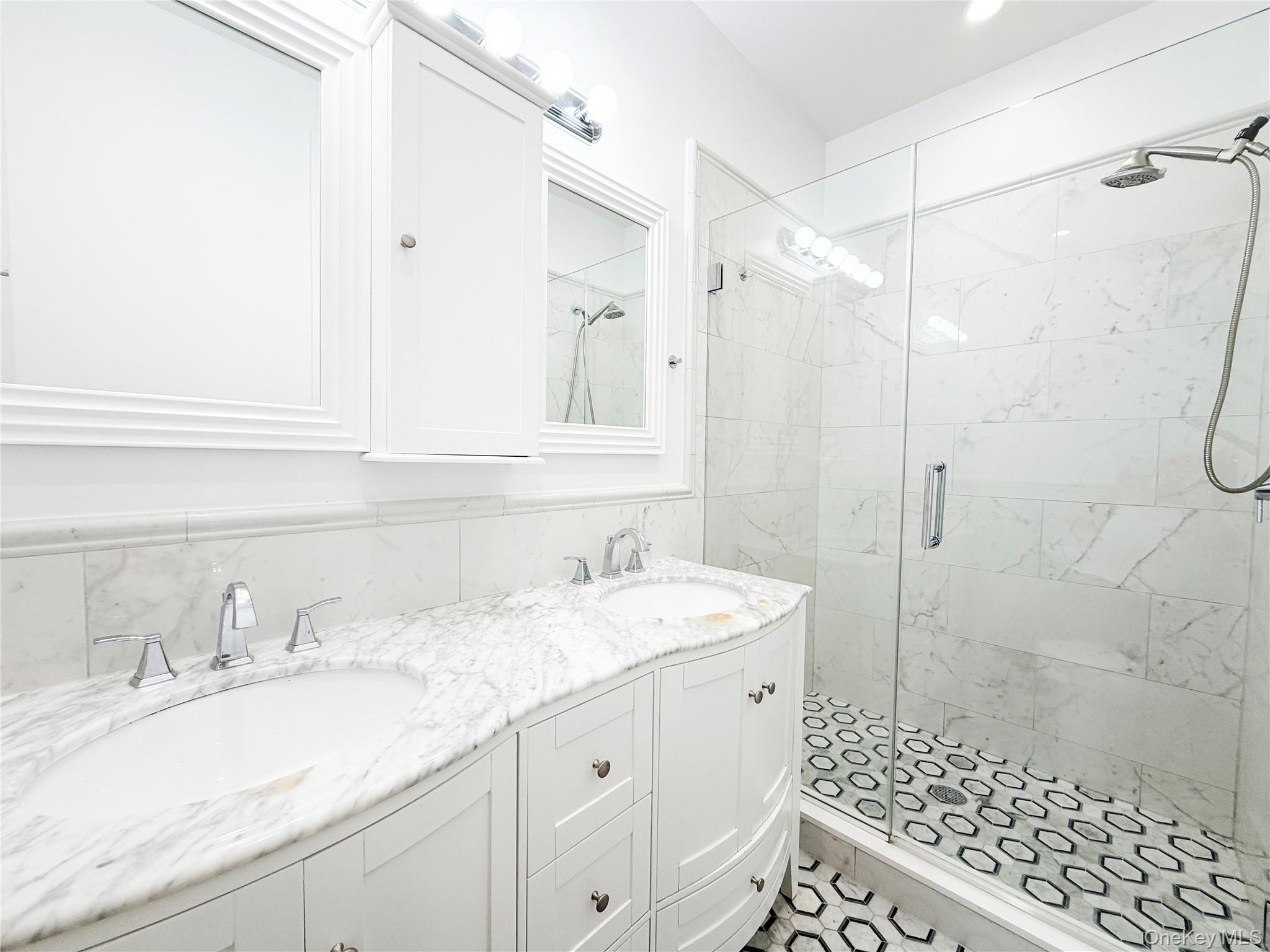 333 Tompkins Avenue, Unit PH2 Brooklyn, NY 11216 - Photo 22 of 33 a bathroom with a sink double vanity and shower