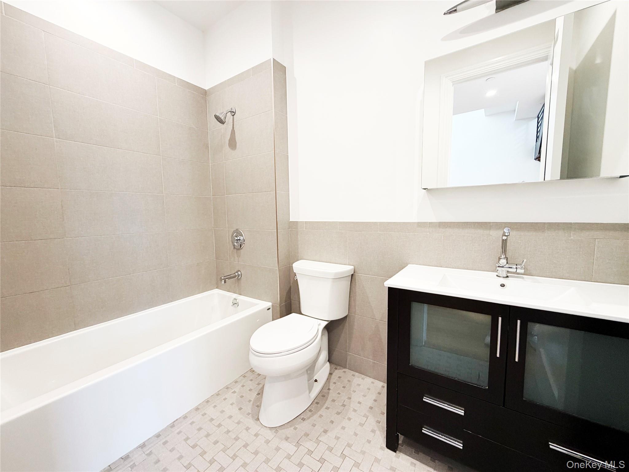 333 Tompkins Avenue, Unit PH2 Brooklyn, NY 11216 - Photo 26 of 33 a bathroom with a toilet a sink and bathtub