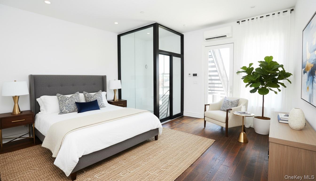 333 Tompkins Avenue, Unit PH2 Brooklyn, NY 11216 - Photo 29 of 33 a bedroom with a large bed and a potted plant