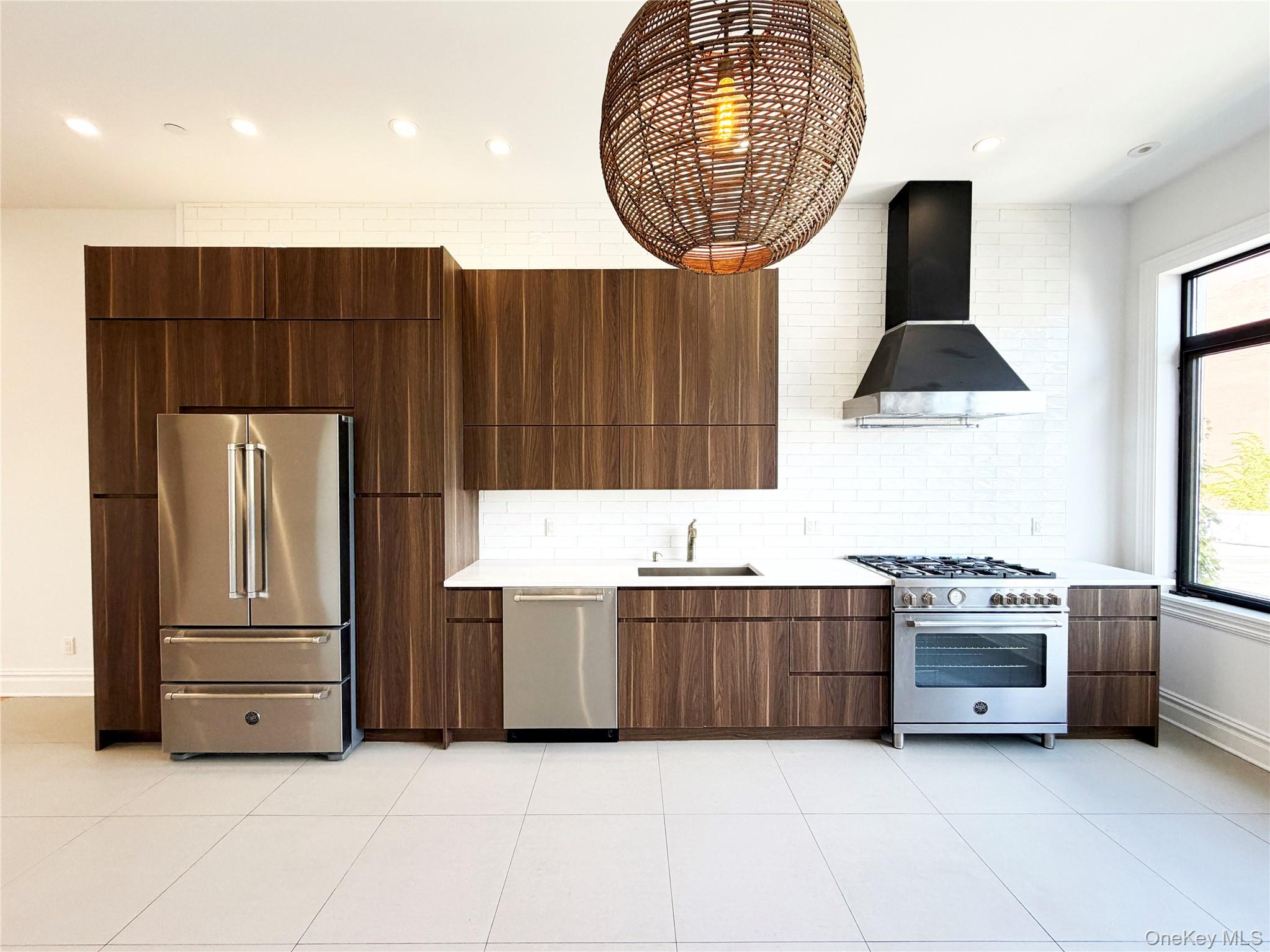 333 Tompkins Avenue, Unit PH2 Brooklyn, NY 11216 - Photo 6 of 33 a kitchen with stainless steel appliances a stove a microwave and a sink