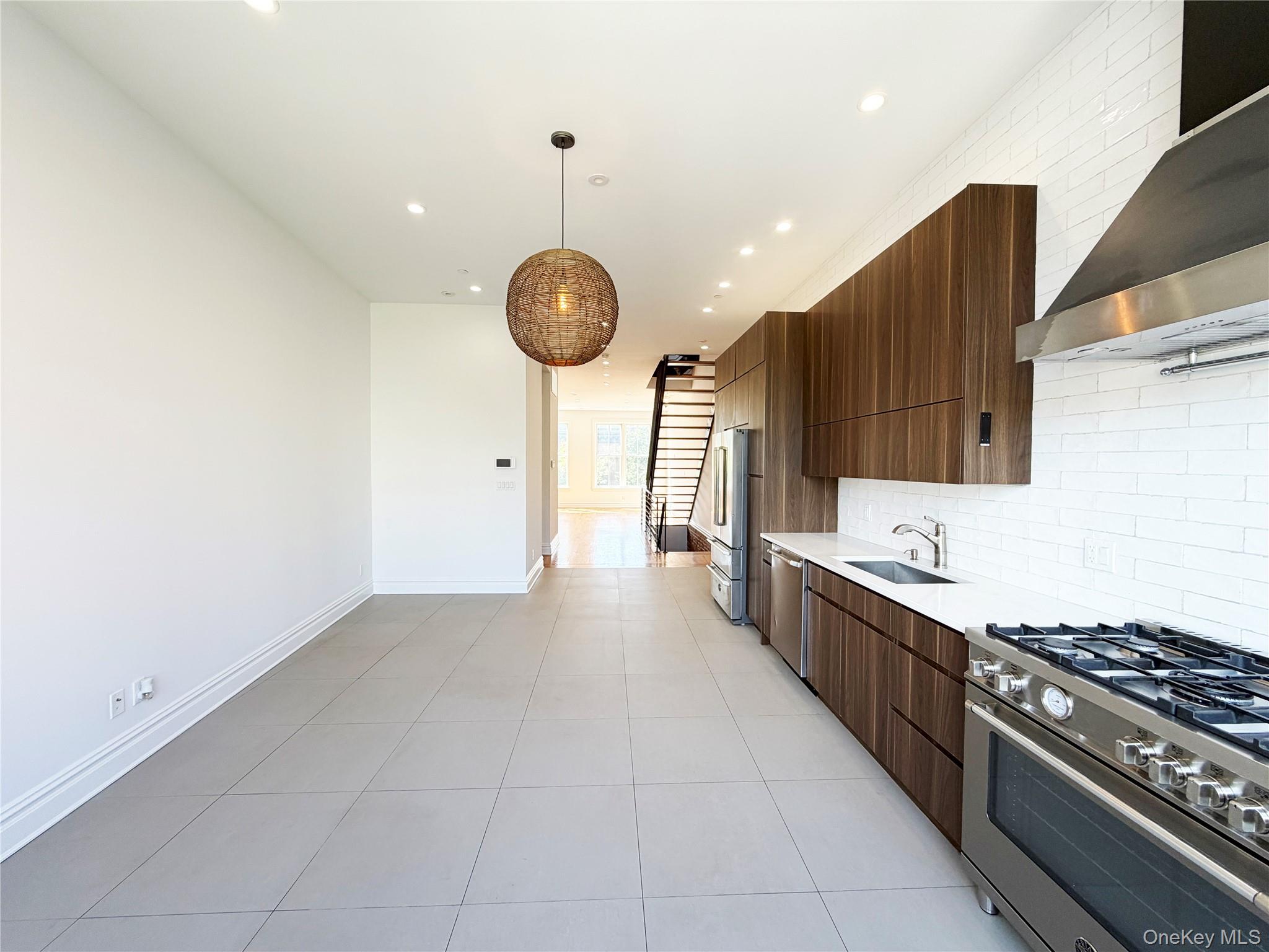 333 Tompkins Avenue, Unit PH2 Brooklyn, NY 11216 - Photo 9 of 33 a kitchen with stainless steel appliances a stove a sink and a refrigerator