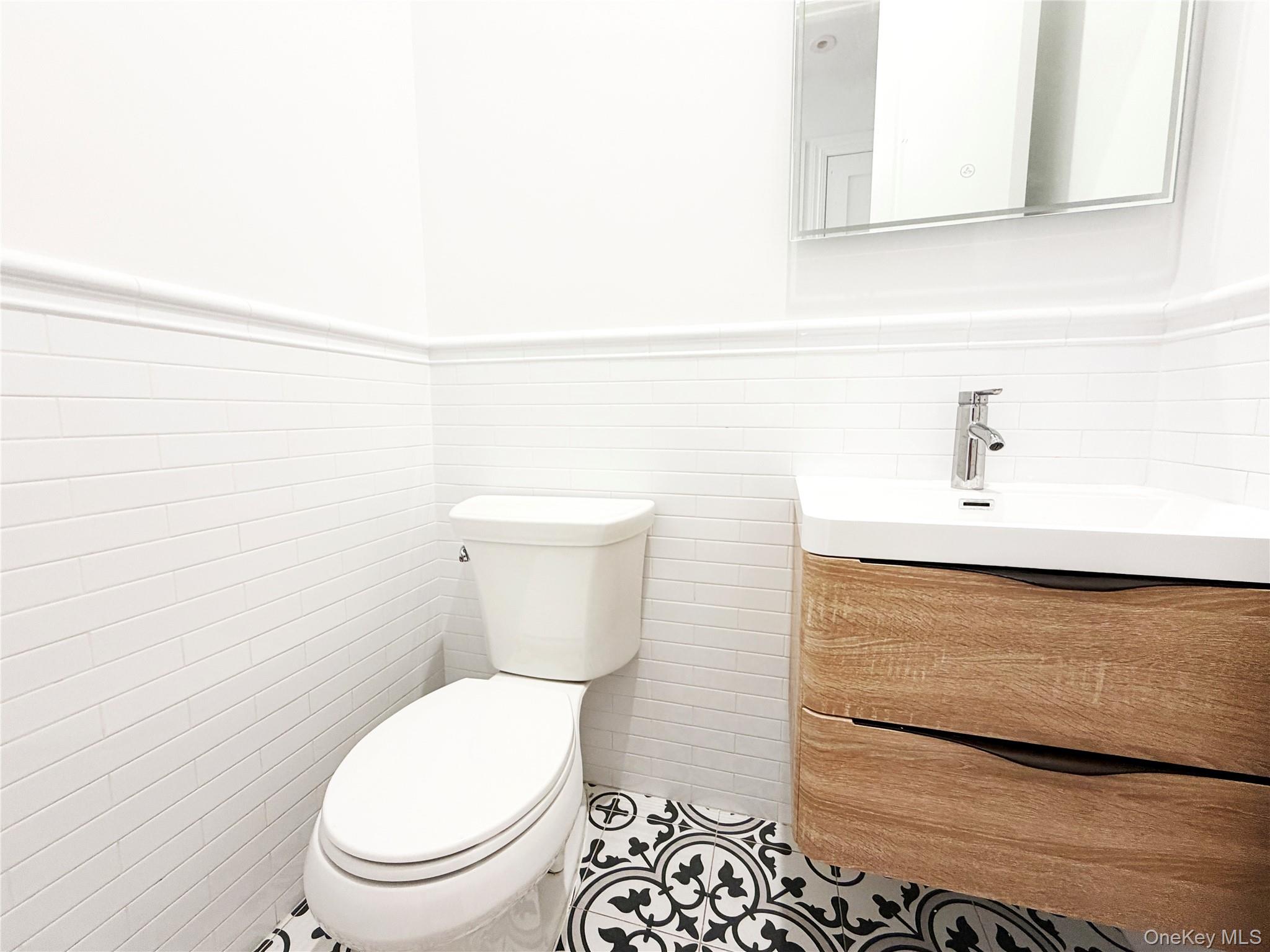 333 Tompkins Avenue, Unit PH2 Brooklyn, NY 11216 - Photo 10 of 33 a white toilet sitting next to a bathroom sink