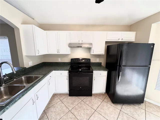 a view of a room with wooden floor and white doors