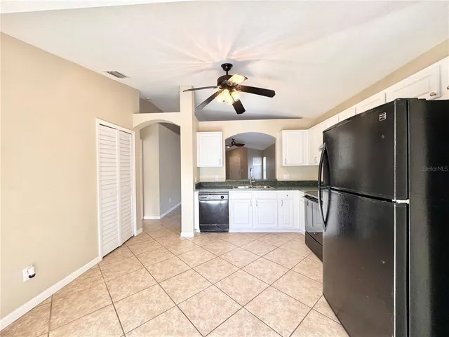 a view of a livingroom with a ceiling fan and window