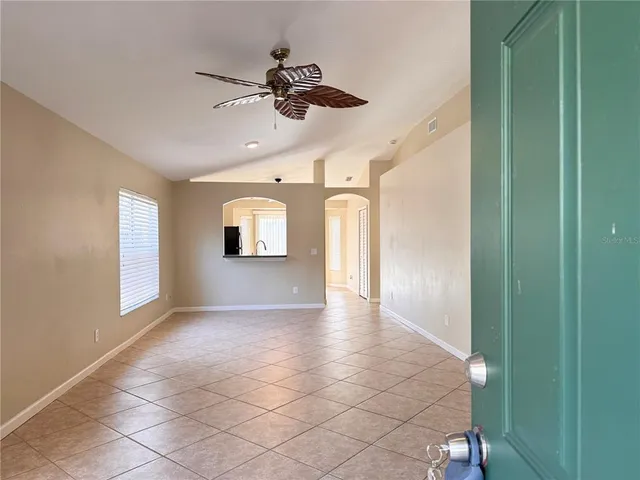 a view of room with window and ceiling fan