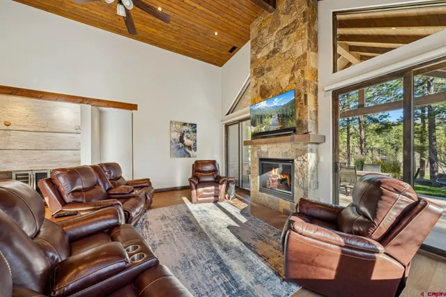 a living room with furniture a rug and a window