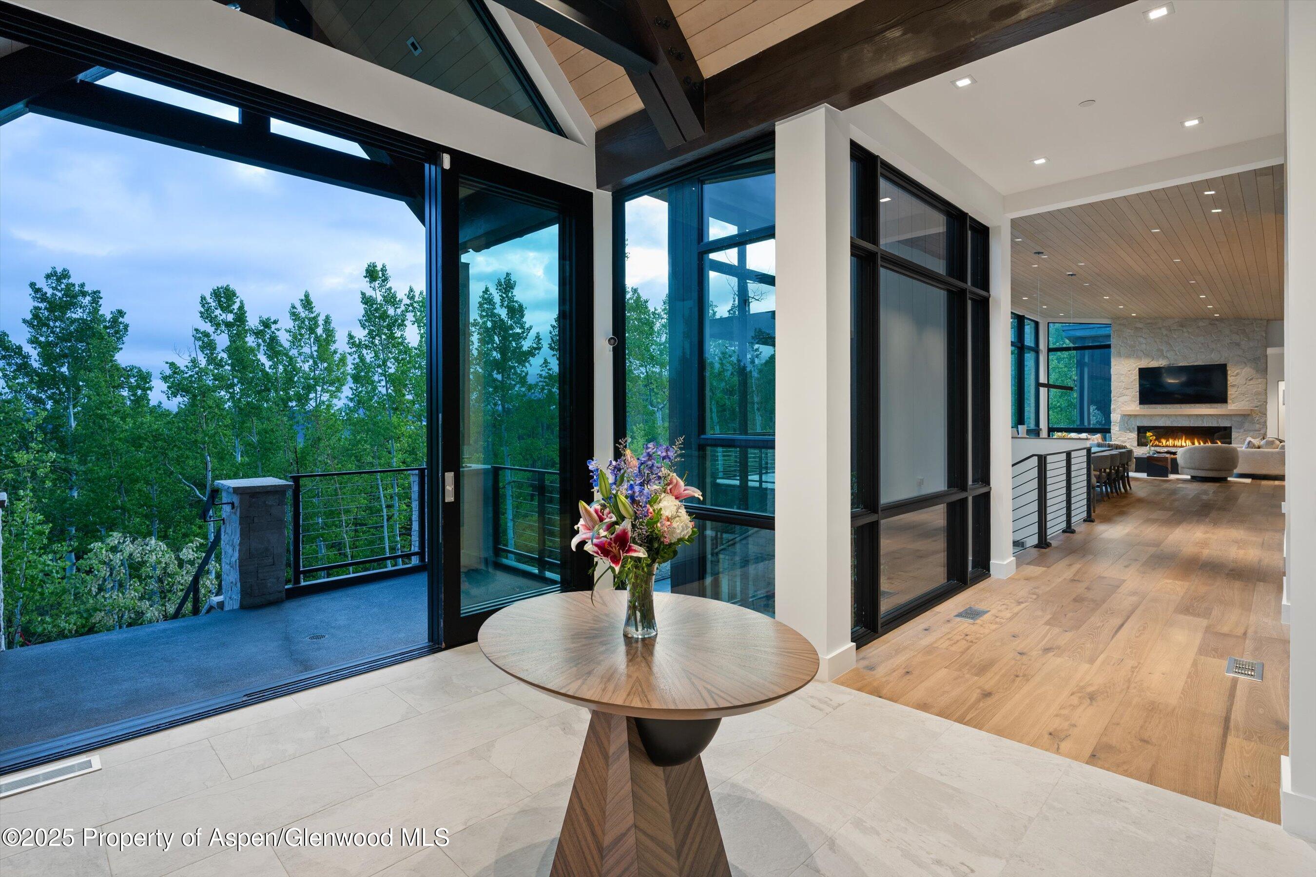 1234 Wood Road Snowmass Village, CO 81615 - Photo 8 of 66 a dining room with furniture and a floor to ceiling window