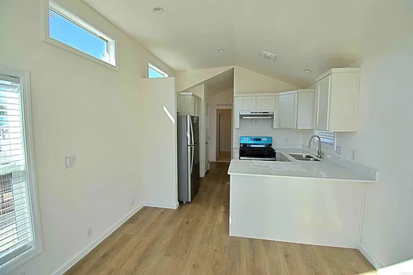 a kitchen with a sink a refrigerator and a stove