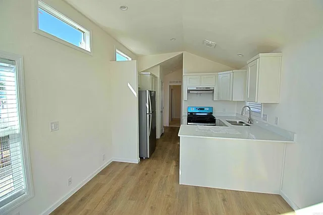 a kitchen with a sink a refrigerator and a stove