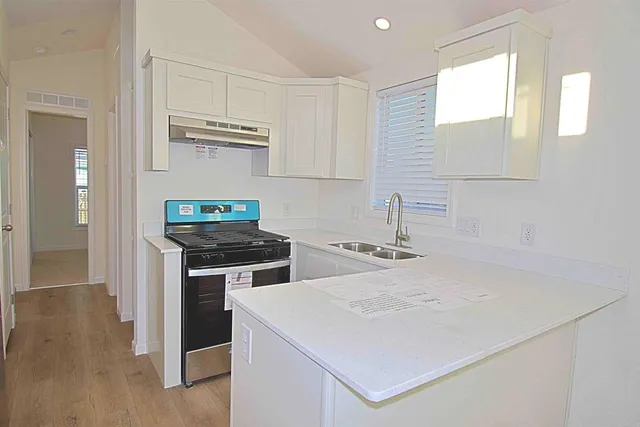 a kitchen with a stove and a sink