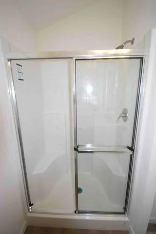a bathroom with a glass shower door