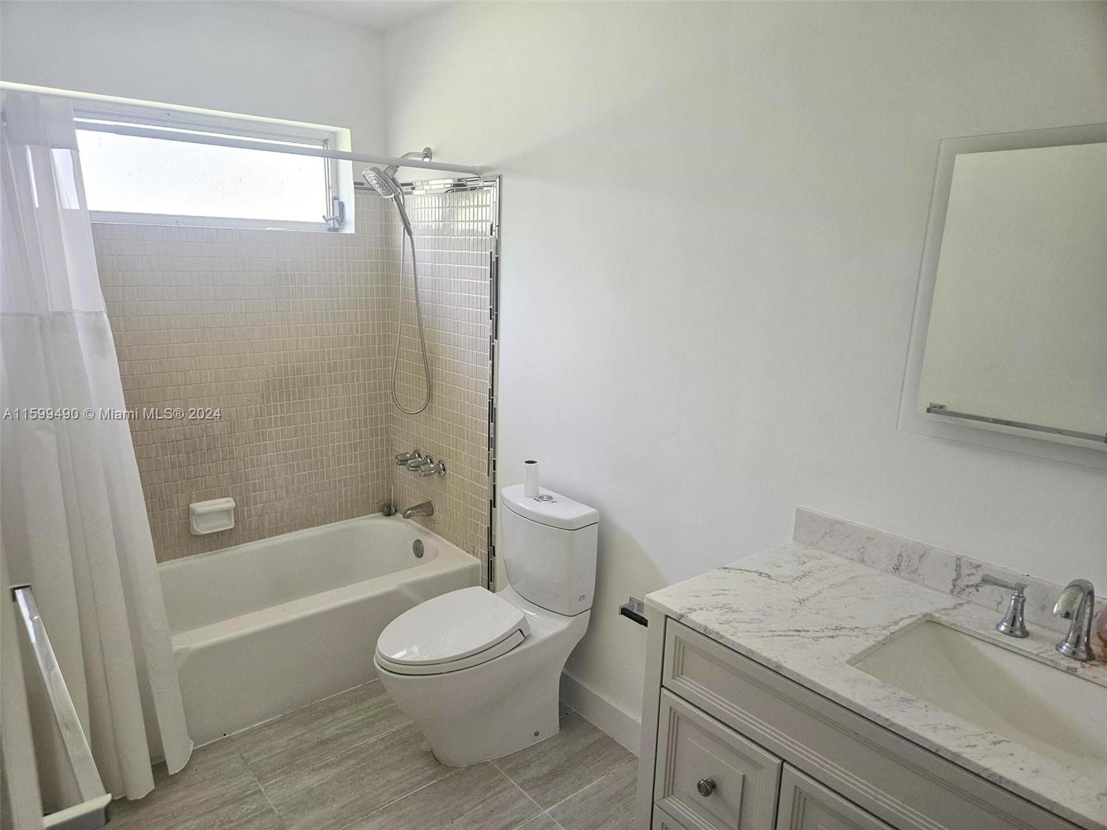 10470 Southwest 93rd Street Miami, FL 33176 - Photo 11 of 14 a bathroom with a granite countertop sink a toilet and shower
