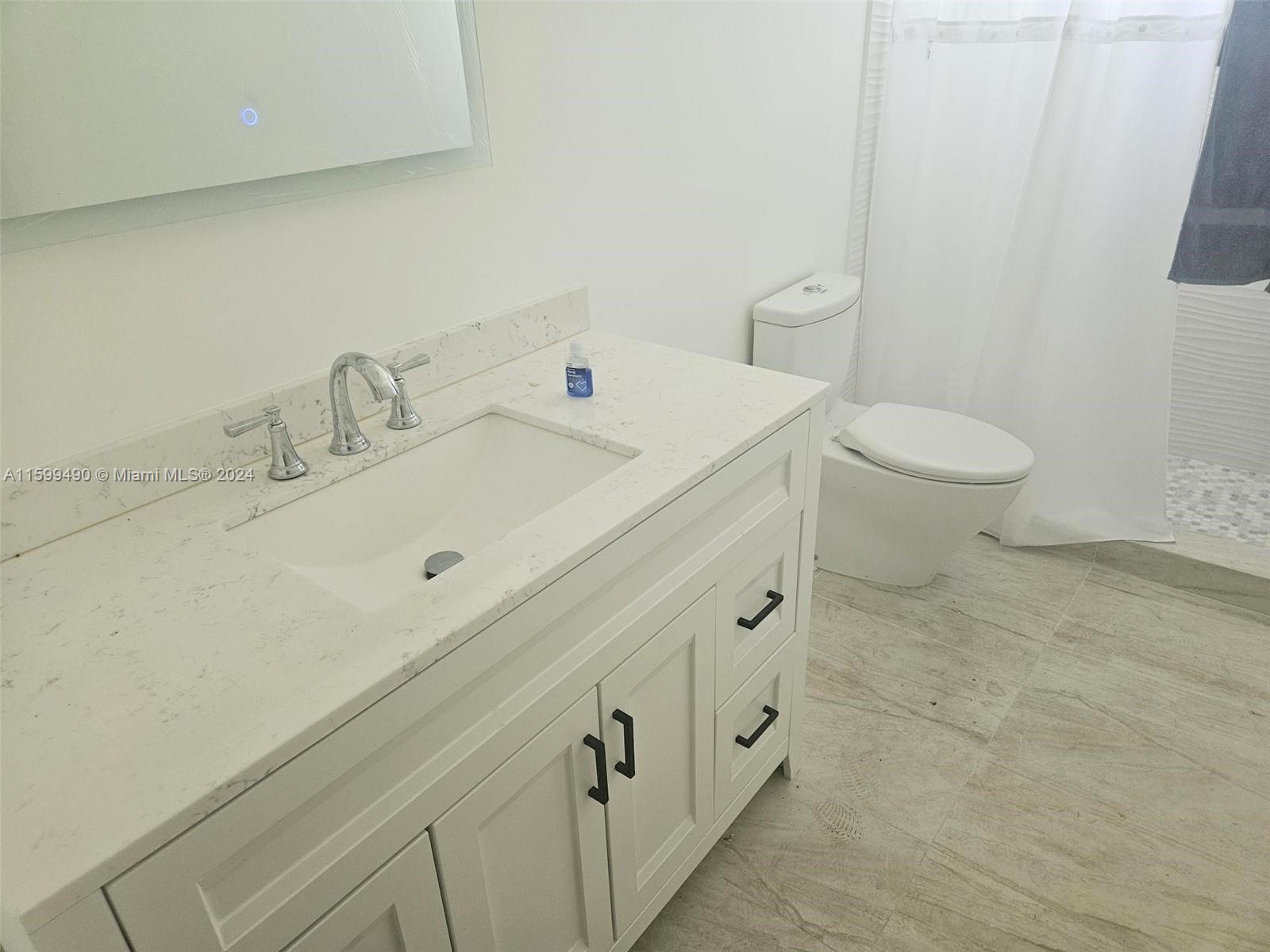 10470 Southwest 93rd Street Miami, FL 33176 - Photo 13 of 14 a bathroom with a sink and toilet