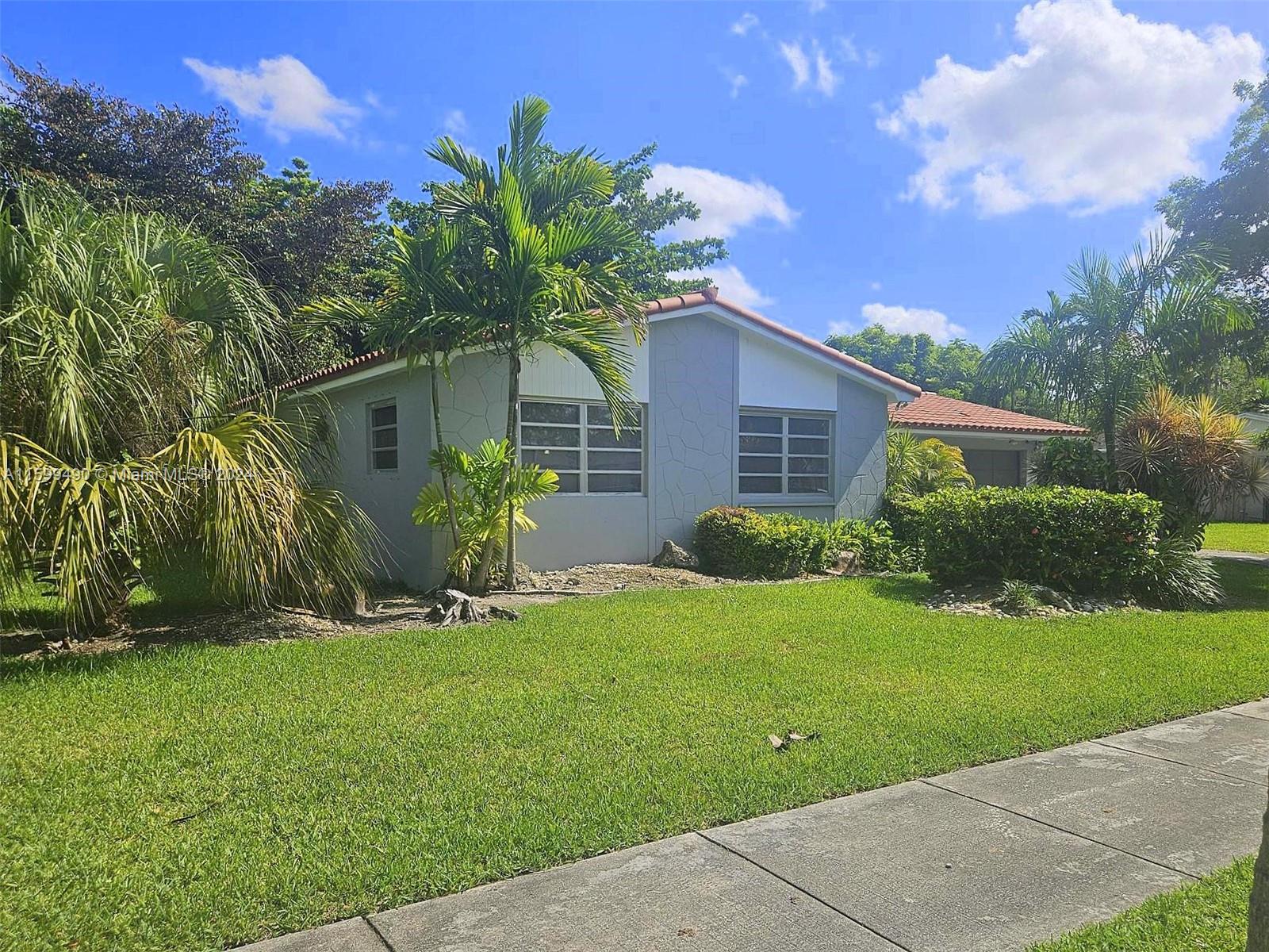 10470 Southwest 93rd Street Miami, FL 33176 - Photo 3 of 14 a front view of a house with garden
