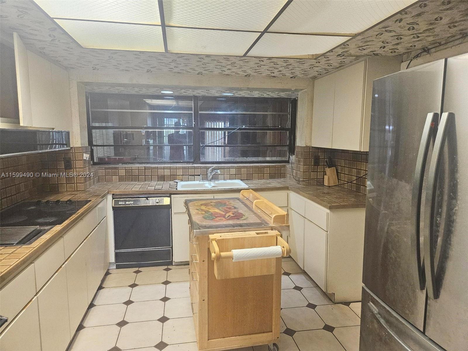 10470 Southwest 93rd Street Miami, FL 33176 - Photo 7 of 14 a kitchen with a stove top oven and refrigerator
